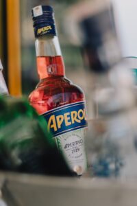Close-up of a sealed Aperol bottle, perfect for cocktail enthusiasts.